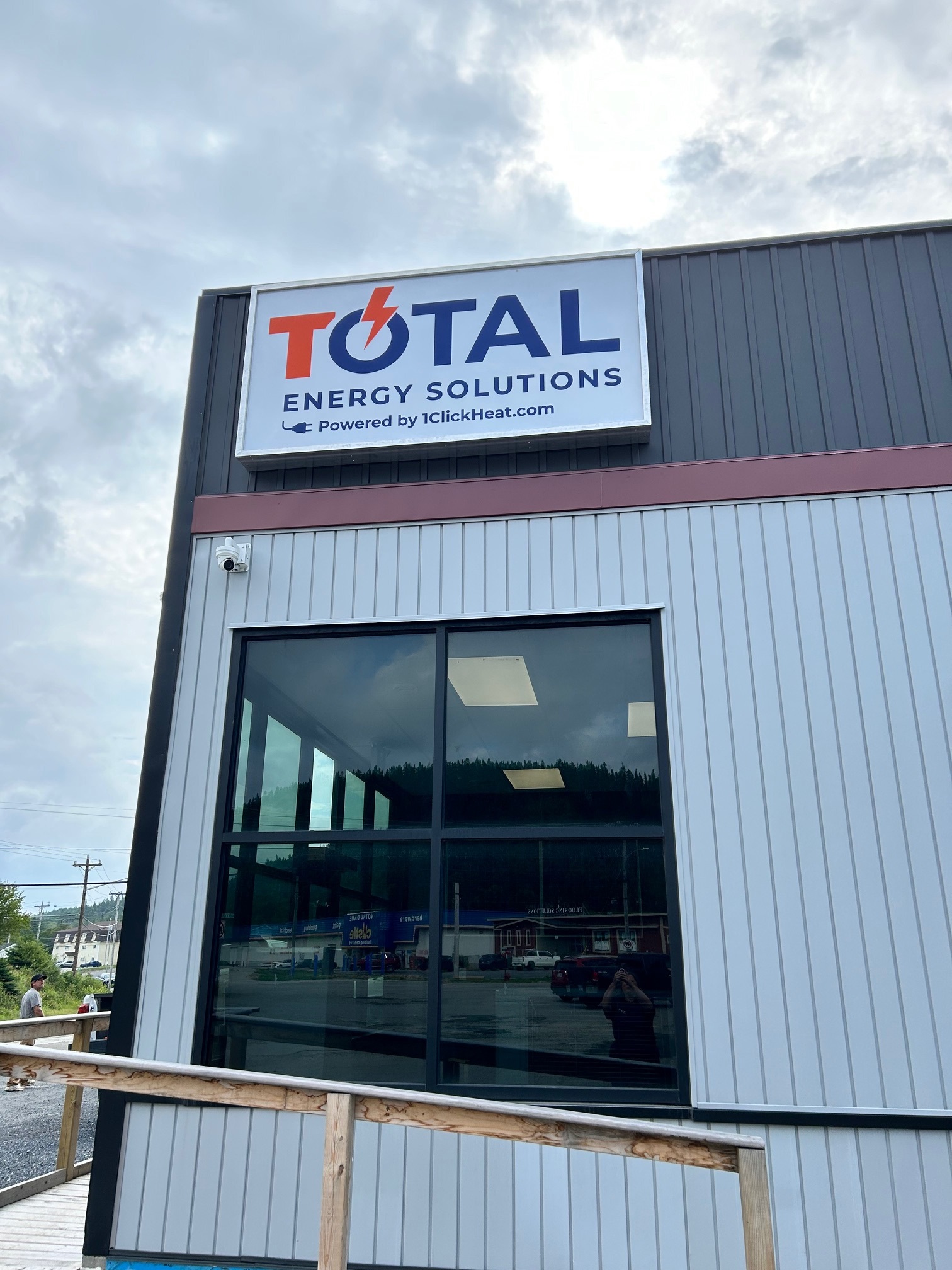 a building with a sign saying Total Energy Solutions powered by 1clickheat.com on the side